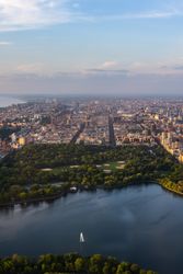 New York Cityscape During Daytime. Aerial Photo from a Helicopter. Modern Skyscraper Buildings Around Central Park in Manhattan Island. Focus on Nature, Trees and Lakes in the Park in the City