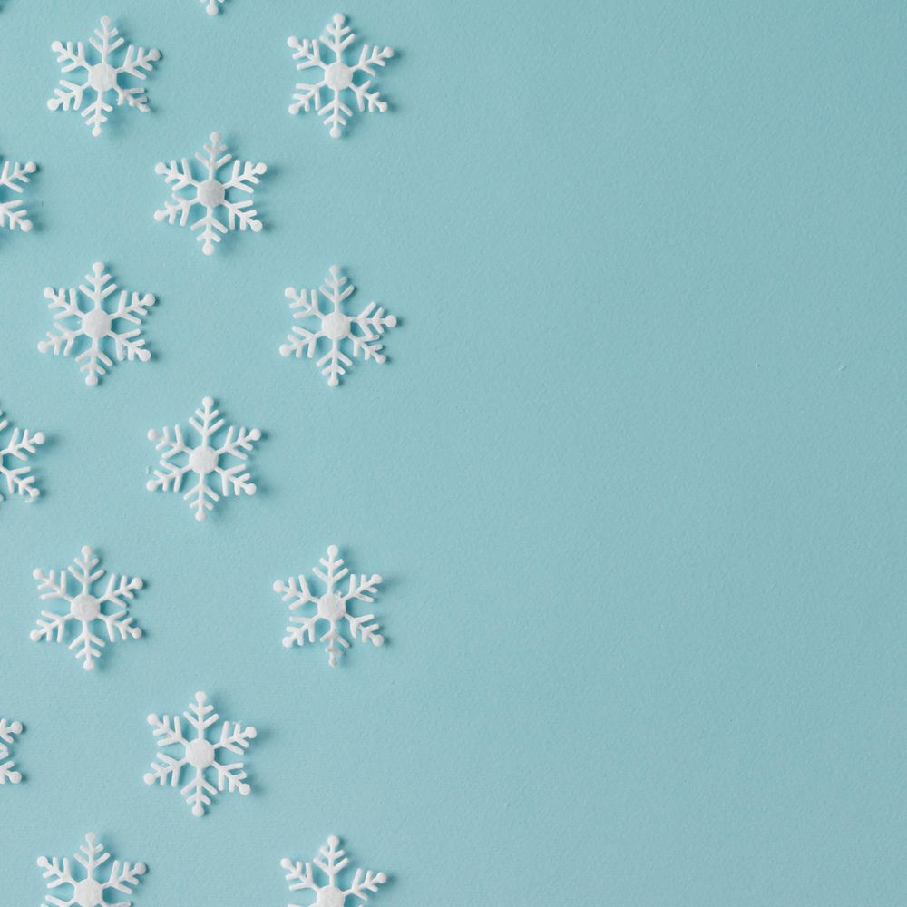 Winter pattern made of uniform snowflakes on blue background