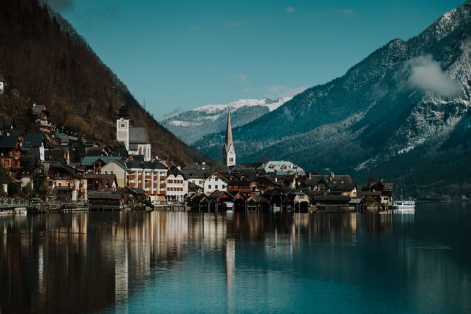 Mountain coast with houses along turquoise lake