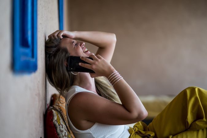 Woman with phone on oriental stone terrace