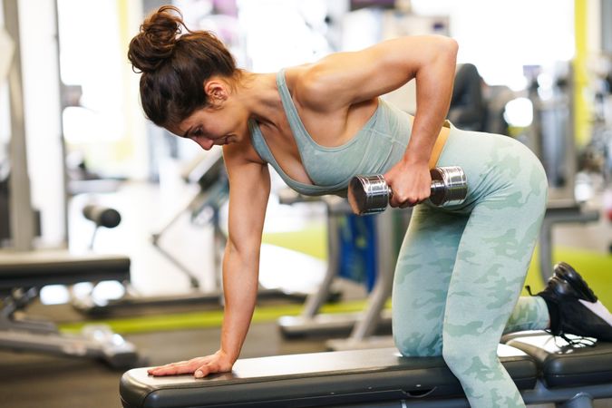 Woman exercising her arms in gym