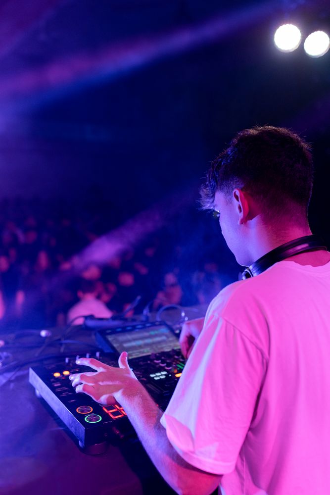 A DJ mixing on stage using board