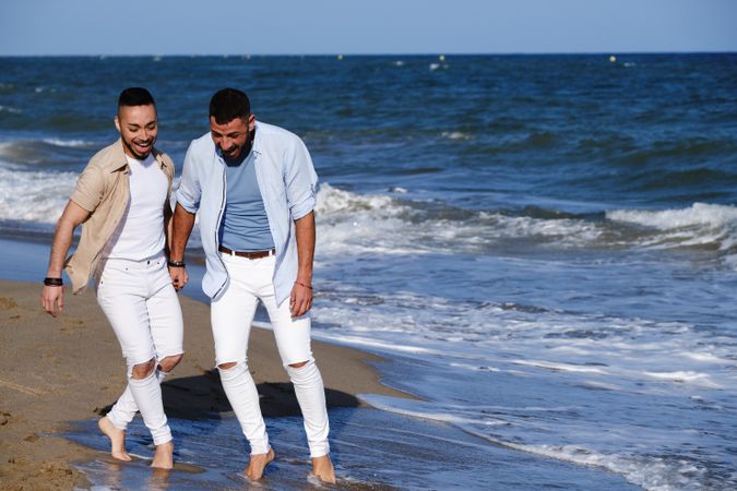 Gay couple walking on beach