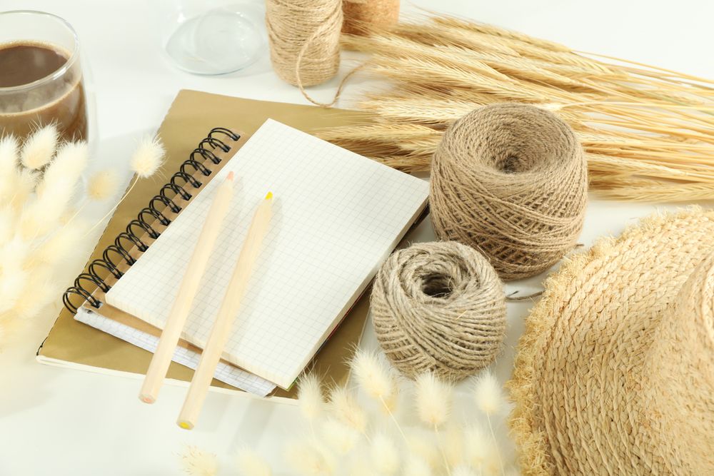 Table with notebook, pencils and willows
