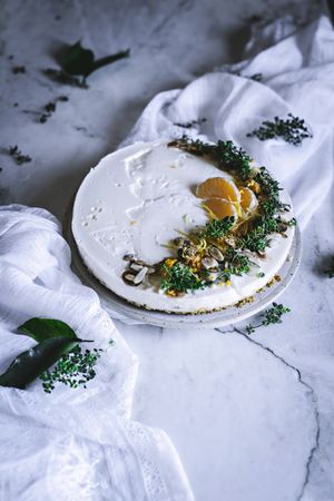 Tangerine cake decorated with whipped cream and sliced citrus