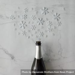Champagne bottle with snow flakes on marble background 4jXxr0