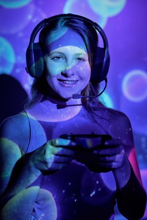 Glad female gamer with controller