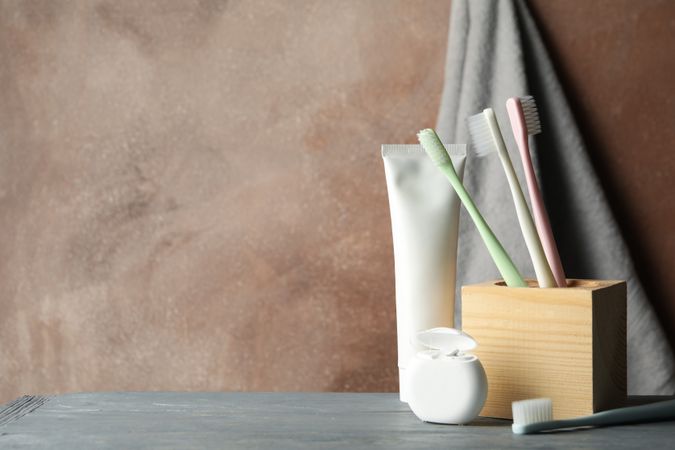 Tools for dental care on brown background, space for text
