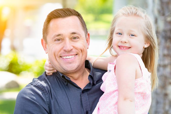 Father and Daughter Having Fun At The Park