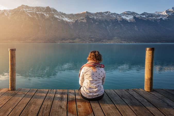 woman on pier in mountains