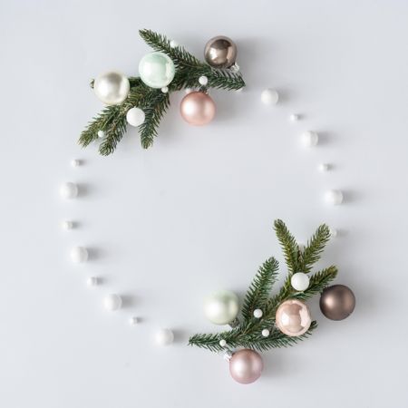 Modern Christmas wreath made of decorative baubles and branches