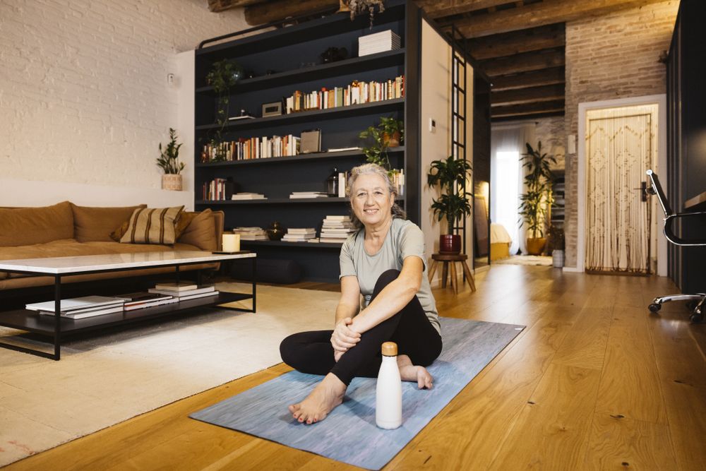 Mature Woman doing yoga at home