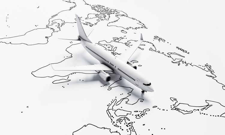Plane model going over drawn map travel plane