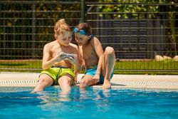 Boys on poolside taking selfie