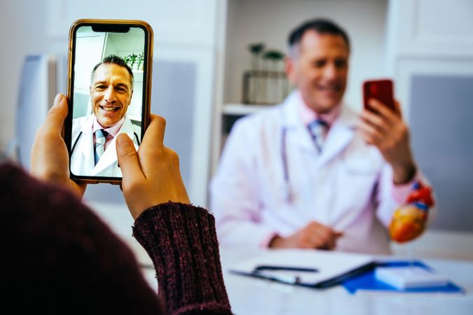 Smiling physician on video call from his office