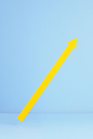 Yellow arrow pointing up over blue background