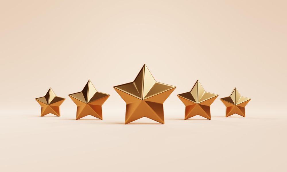 Gold star ornaments on beige background