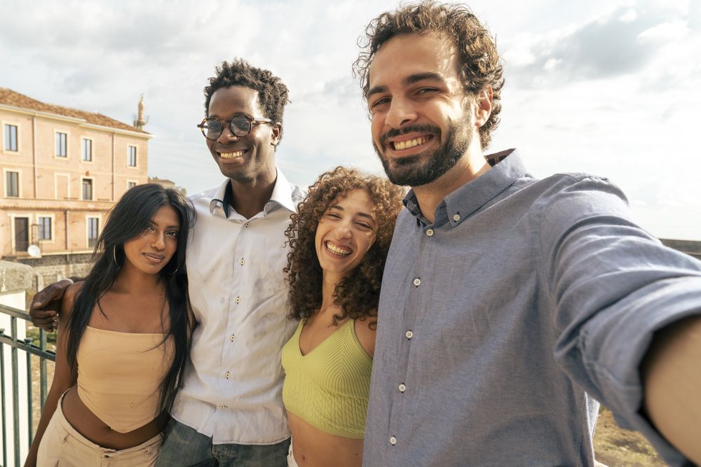 Group of young multicultural friends taking a selfie on vacation.
