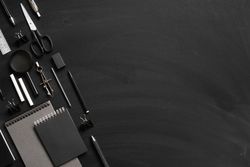 Stationary arranged neatly on dark background with copy space