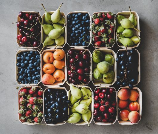Rows fresh fruit arranged together in eco-friendly boxed