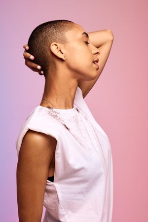 Bald woman standing against colorful background