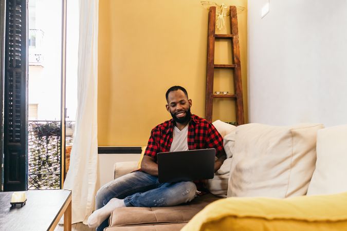 Black man using laptop at home