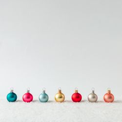 Row of Christmas bauble decorations on snow