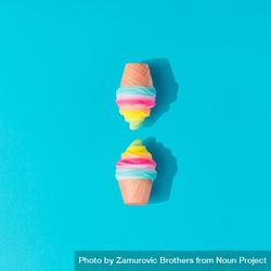 Two colorful ice cream cones on bright blue background 4BBKe4