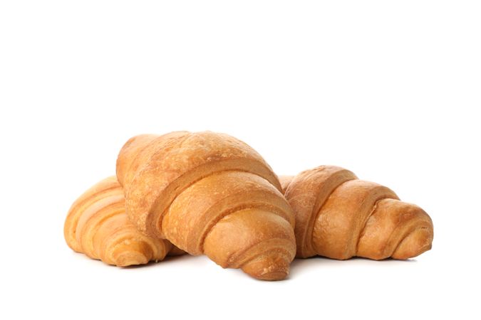 Side view of three croissants isolated on plain background