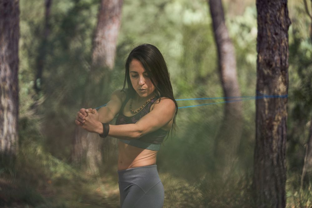 Fit woman doing exercises with elastic band