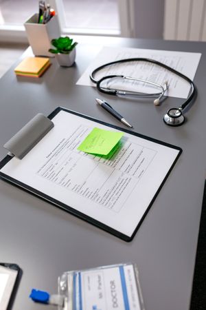 Doctor desk with documents and stethoscope