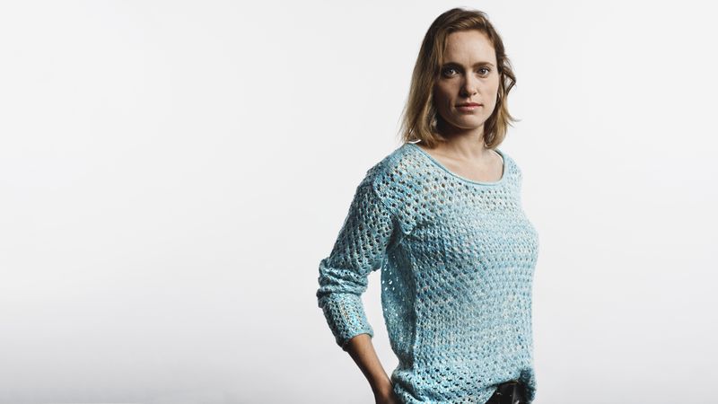 Female wearing a wool top isolated on neutral background