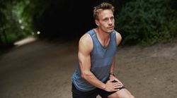 Man in sportswear stretching his quads
