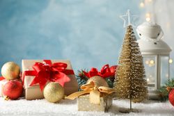Christmas lantern and tree on decorated background, space for text