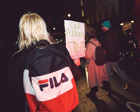 London, England, United Kingdom - March 16, 2021: Rear shot of blonde woman with sign at protest
