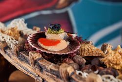 Scallops served on boat in cafe