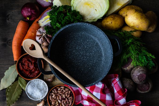 Ingredients for hearty stew surrounding pan