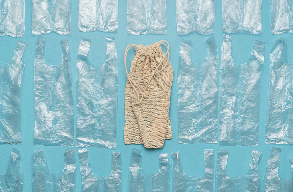 Flat lay with plastic bags and one reusable bag