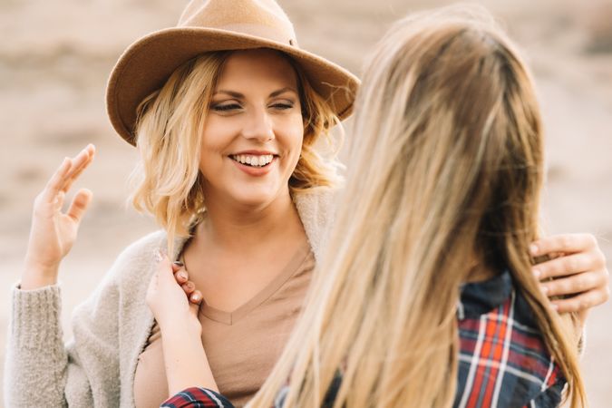 Content blond women cuddling on nature