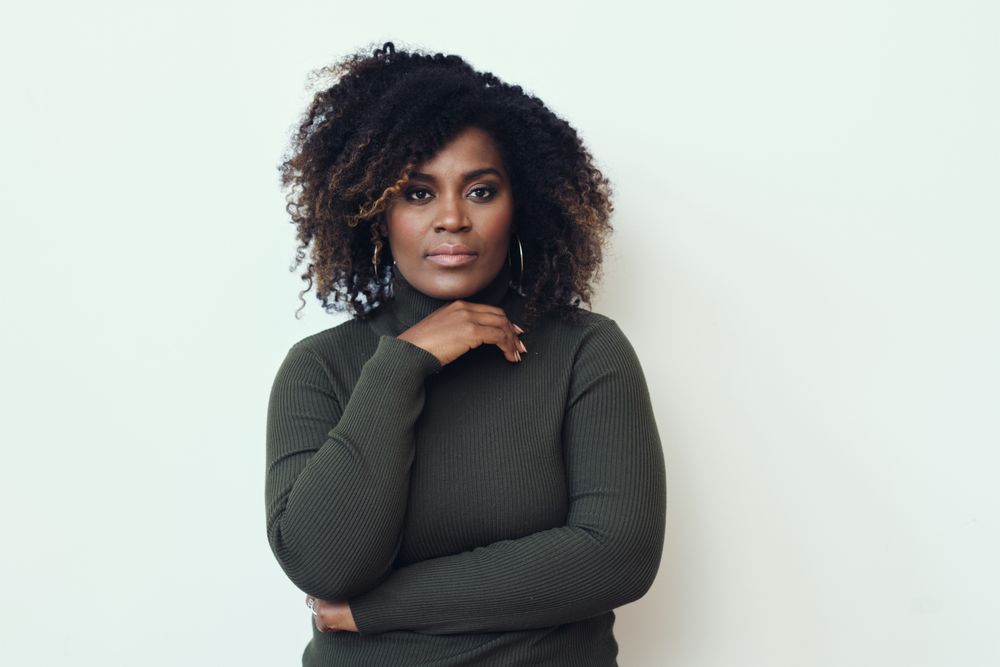 Black woman with her hand under her chin