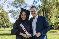 Happy graduated woman with her boyfriend or her brother