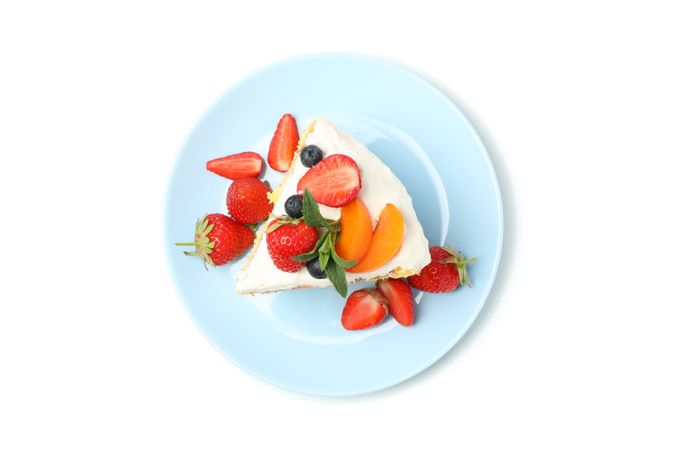 Plate with berry cream cake isolated on plain background