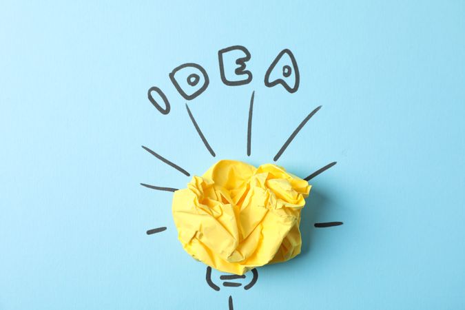 Drawn light bulb and paper ball on blue background. Good idea concept