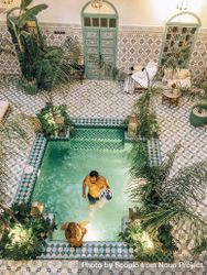Top view of man and woman in swimming pool in a traditional Moroccan house 5ookz5