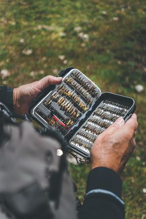 Fisherman demonstrating collection of baiting in box