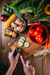 Vegetables and utensils on kitchen table