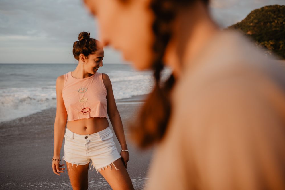 Smiling women looking away on beach