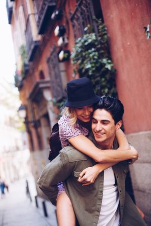 Happy couple having fun while walking in town