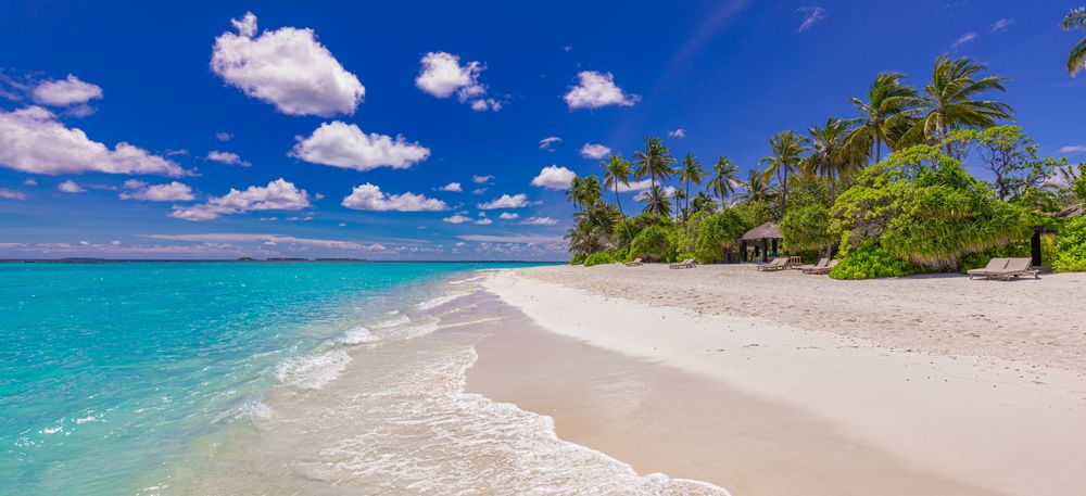 Water front of tropical beach resort with light sand