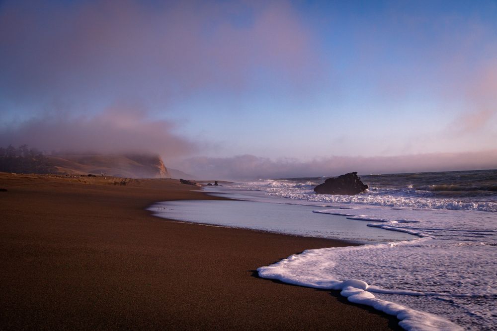 Waves and low clouds coming into west coast beach